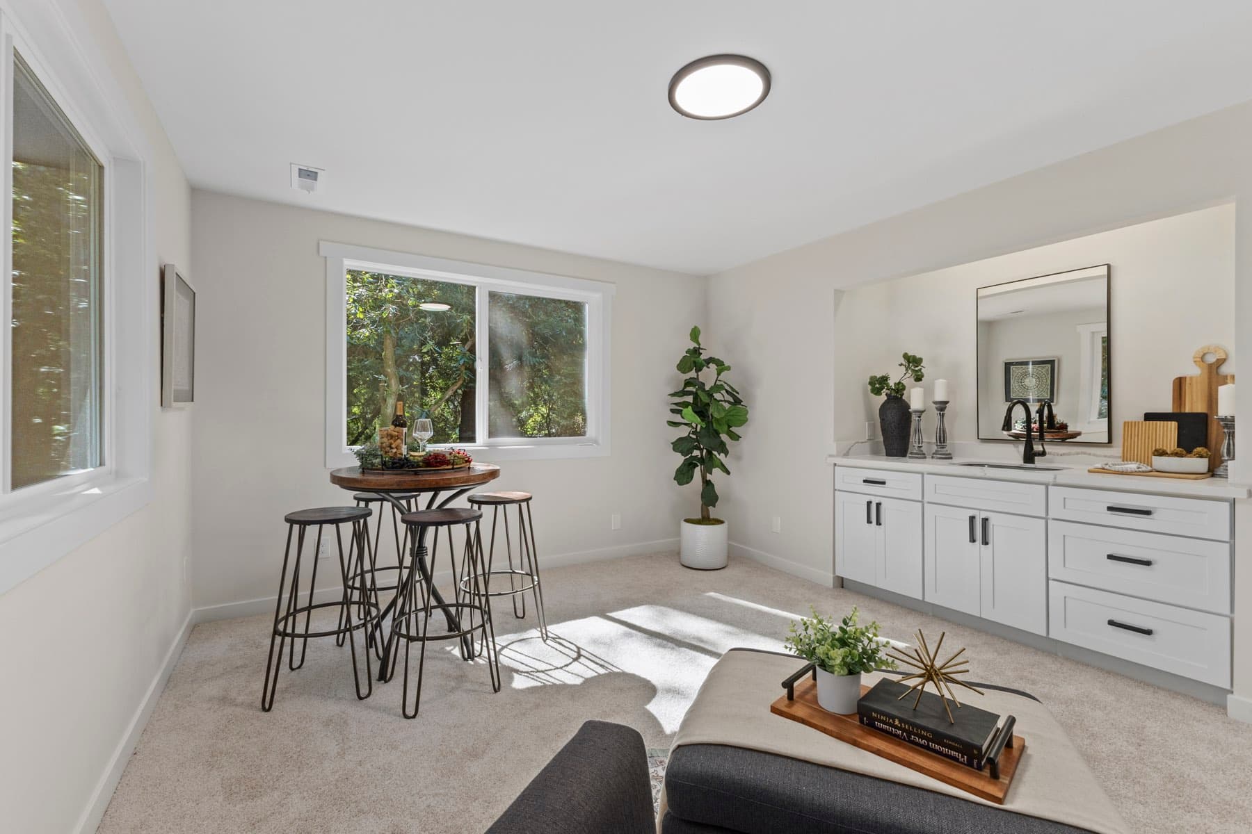 The dining corner after the renovation, staged with a round table under a window.