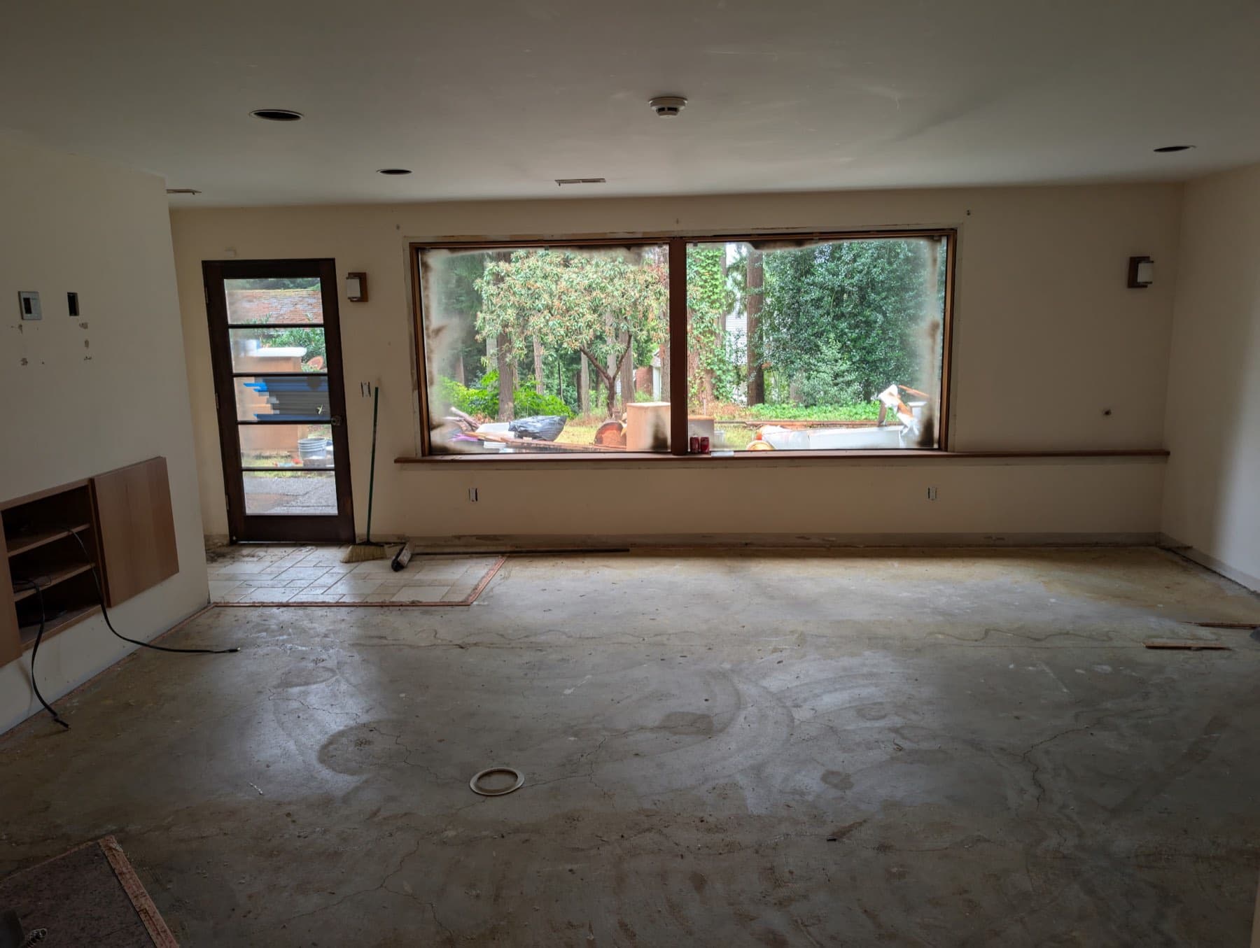 The living room as it was, stripped to the subfloor.