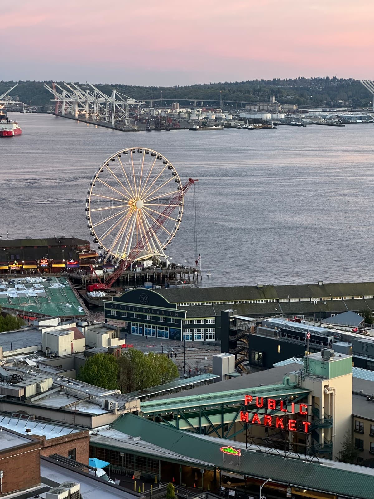 Pike Place Market's waterfront and the Seattle Great Wheel at dusk.