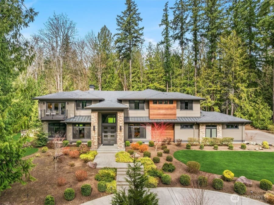 A Northwest home from the street, its planting trimmed back and the entry path clear.
